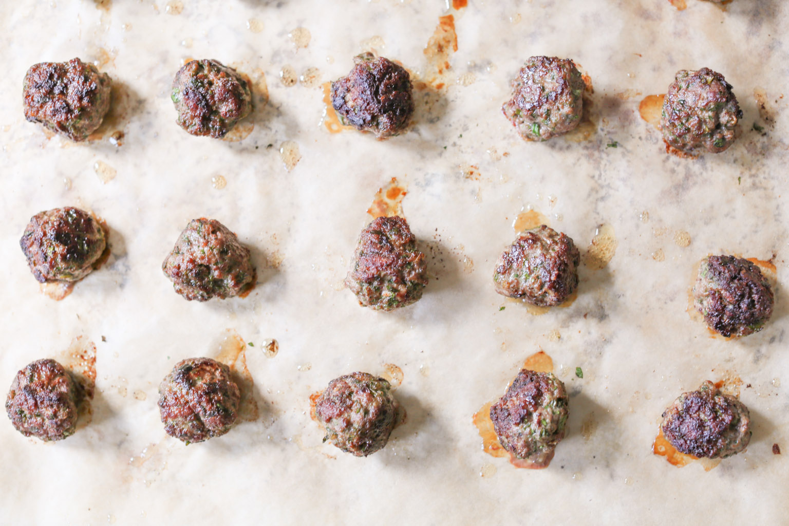Lamb kofta on a baking sheet after being removed from the oven.